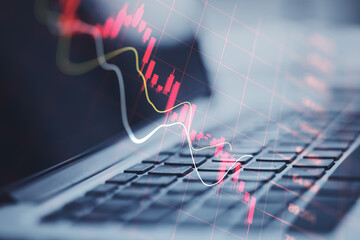 Global economic recession, stock market crash and inflation concept with digital falling down red candlestick and diagram on modern laptop keyboard background, double exposure