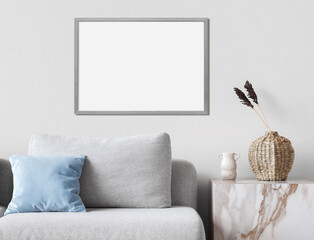 Empty horizontal frame mockup in modern minimalist interior with plant in trendy vase on white wall background. Template for artwork, painting, photo or poster. Real photograph