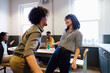© Westend61 - Cheerful business colleagues dancing with each other at office