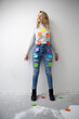 © Westend61 - Smiling woman with colorful adhesive notes on body standing in front of wall