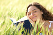 © Antonioguillem - Happy woman reading a book between wheat