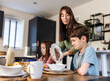 © Westend61 - Mother serving breakfast to son at table