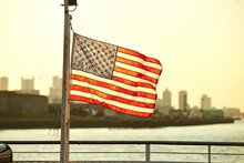 American Flag Against Boston Skyline At Sunset, Massachusetts, USA