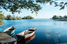 Two Row Boats Tied To A Little Harbor At A Little Bay In Playa Larga, Cuba