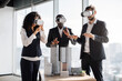 © sofiko14 - VR, business meeting conference. Multiethnic male and female business people wearing virtual reality headsets, touching air and gesturing at the office, working with new project or program.
