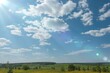 © MarinaLye - A field of yellow dandelions in a summer timelapse, clouds float across the blue sky, the rays of the sun penetrate through the clouds. Forest in the background. Outdoor recreation