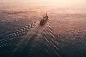 Small Fishing Boat catch fish, aerial Top View from drone. Industrial commercial fishing.