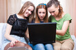 © danmorgan12 - Modern Lifestyle. Three Young Positive Laughing Caucasian Girlfriends Having Fun With Personal Laptop Computer Indoors.