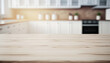 © Limitless Visions - Selective focus.Wood table top counter island  and blur kitchen room background.ai generated images