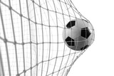 Fototapeta  - Soccer ball scores a goal on the net in a football match