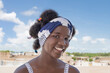 Cheerful girl standing on a terrace, Afro hairstyle and pigtails, photo