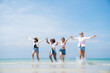 © kelvn - Happy friends at beach party runs together on the beach having fun in a sunny day, Beach summer holiday sea people concept