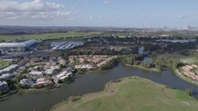 Cbus Super Stadium And Surrounding Waterfront Community Houses In The Town Of Robina In Queensland, Australia. Aerial Pan Right