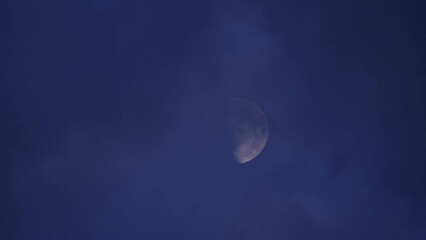 Wall Mural - moon shrouded by thick clouds at night. - static
