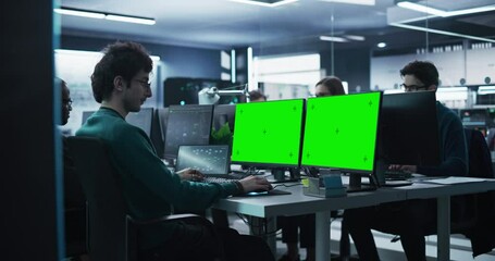 Fototapete - Group of Diverse Multicultural Men and Women Working on Desktop Computers in a Research Center. Young Software Developer Working on a Computer with Two Green Screen Mock Up Displays