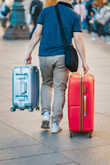  Unrecognizable young man traveling with suitcases, travel and tourism concept
