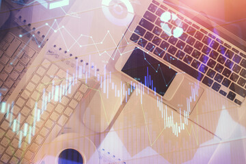 Poster - Financial market graph and top view computer on the desktop background. Multi exposure. Investment concept.