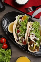 Wall Mural - Delicious fresh vegan tacos served on wooden table, flat lay