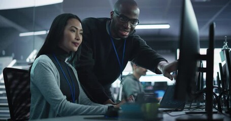 Poster - Two Diverse Multiethnic Colleagues Having a Conversation While Busy Working on a Team Project. Asian Female Designer Talking with an African Project Manager. Teamwork in Technology Laboratory