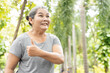 © 9nong - Exciting  successful old asian senior woman giving thumb up gesture with happy and positive feeling in outdoor green park