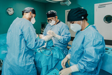 Wall Mural - Medical doctors team operating patient in surgical room at hospital - Focus on center surgeon face