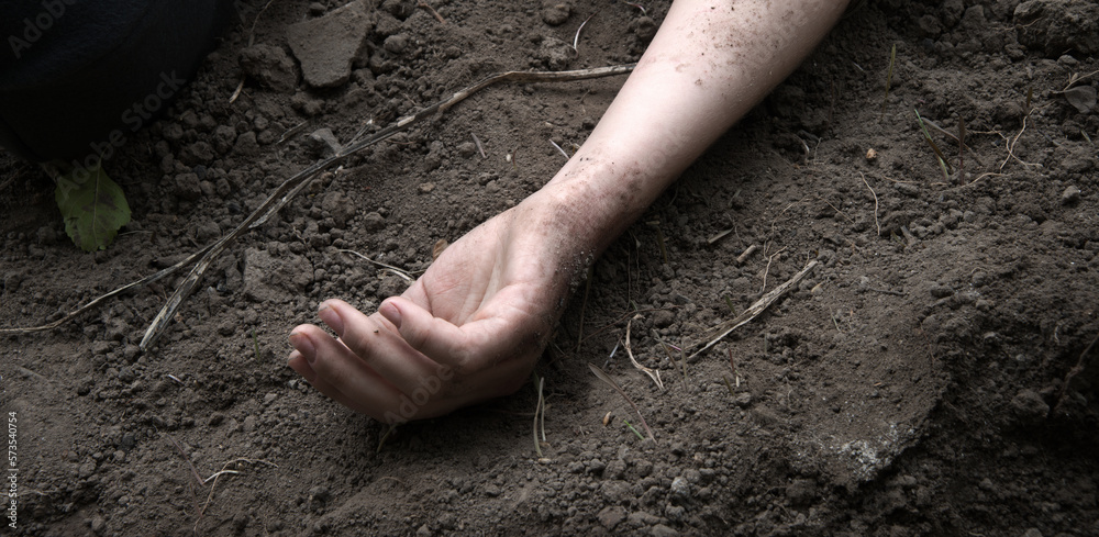 Hand of a wounded soldier on the ground