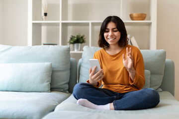 Online Communication. Happy Arab Woman Making Video Call Via Smartphone At Home