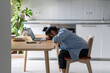 Tired Asian freelancer woman was exhausted from hard work at laptop take nap on table from overwork. High quality photo