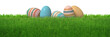Colorful stripes decorated easter eggs in natural green spring grass lawn isolated