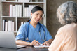 © amnaj - Asian female doctor examining a patient to assess the illness for proper treatment.