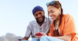 © Siphosethu F/peopleimages.com - Couple, diversity love and phone in nature, outdoors or outside on holiday, vacation or trip. Happy, smile and man, woman and 5g mobile app, social media or web surfing online on tech while talking.