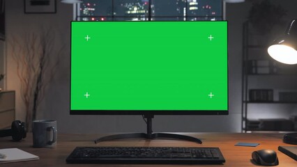 green screen computer on the home desk at night with modern city window in the background,chroma key