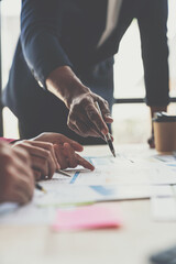 Wall Mural - A group of Asian businessmen are meeting, planning and discussing data analysis, growth charts, graphs, financial calculations, marketing, revenue management. Various taxes within the joint office.