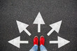© olyphotostories - Feet walking away with many directions arrow. Taking decisions for the future sneaker shoes top view road. Selfie student child standing on floor or pathway to success. Creative idea, future concept