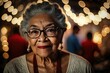Aged well: close-up portrait of happy senior BIPOC woman looking at camera. Nice bokeh background.
