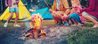 © candy1812 - Group of the people sitting near the campfire and cooking marshmallows.