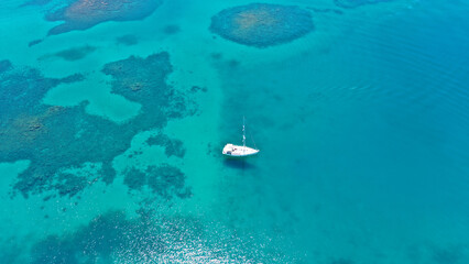 Wall Mural - Aerial drone photo of beautiful sail boat sailing in tropical exotic bay with emerald clear sea