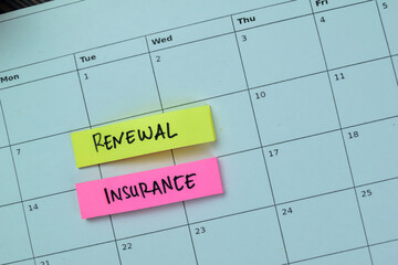 Wall Mural - Concept of Renewal Insurance write on sticky notes isolated on Wooden Table.