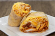 Egg and crispy potato breakfast burrito filled with rice, cheese, and salsa for a very large appetite