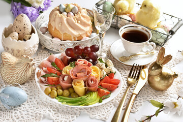 Wall Mural - Easter table with a platter of ham and cheese appetizer and ring cake