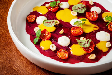 Wall Mural - beetroot carpaccio with sauce, on white plate