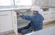 © Lumeez/peopleimages.com - Sink repair, home maintenance and kitchen water pipe check of handyman in a house. Contractor man, builder service and filter improvement installation of a construction employee working in household