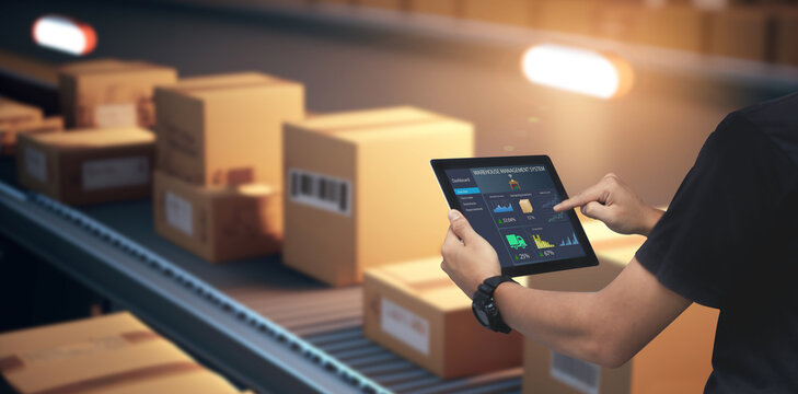 smart warehouse,inventory management system concept.manager using digital tablet,showing warehouse s