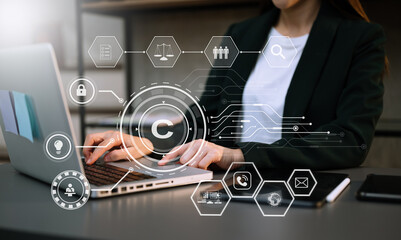 Wall Mural - Copyright or patent concept, Person hand using laptop computer, tablet and smartphone with virtual screen copyright icon trademark, Creation ownership against piracy. at office.