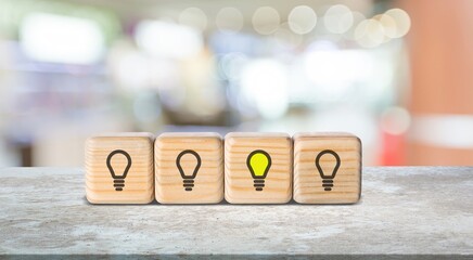 Sticker - Set of wooden cubes blocks with light-bulb on the desk