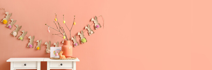 Sticker - Vase with tree branches and Easter decor on tables near pink wall. Banner for design