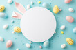 Easter concept. Top view photo of empty circle easter bunny ears yellow blue pink eggs and sprinkles on isolated pastel blue background with copyspace