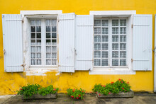 House With Bright Yellow Wall And White Windows With Shutters, Monpazier, Dordogne Department, Aquitaine, France