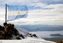 The Argentine Flag Blows In The Wind At The Top Of Cerro Catedral On A Sunny Day In The Andes