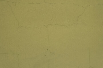 Wall Mural - Close shot of greenish yellow painted wall with cracks